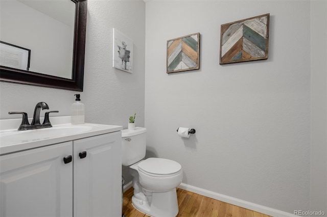 527 English Sparrow Trl, Highlands Ranch, CO 80129 - half bath featuring toilet, vanity, baseboards, and wood finished floors