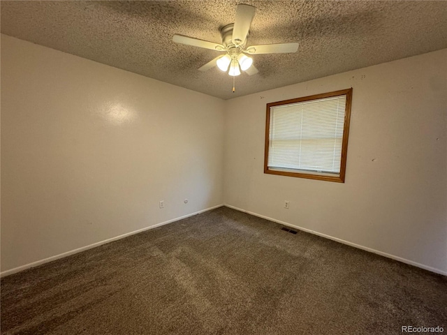 carpeted spare room with ceiling fan and a textured ceiling