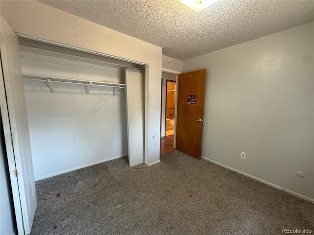 unfurnished bedroom with carpet floors, a closet, and a textured ceiling