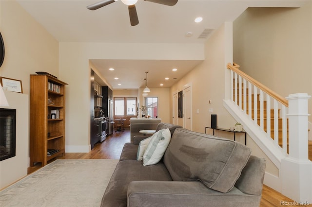 1008 River Park Rd, Buena Vista, CO 81211 - living room featuring light wood-type flooring, a ceiling fan, recessed lighting, stairway, and baseboards