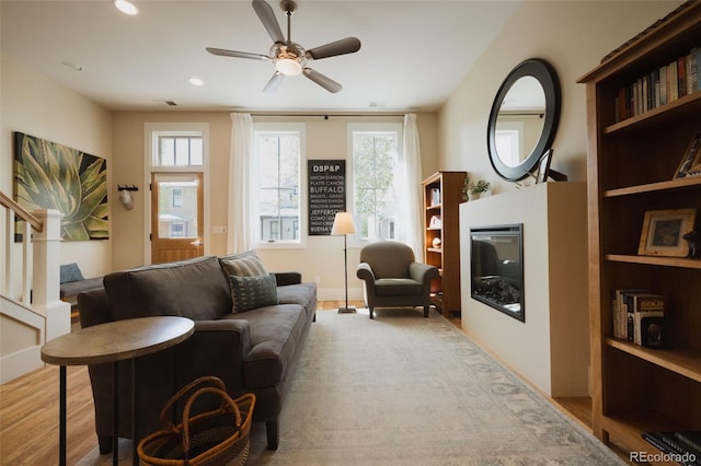1008 River Park Rd, Buena Vista, CO 81211 - living room featuring healthy amount of natural light, a glass covered fireplace, ceiling fan, wood finished floors, and recessed lighting