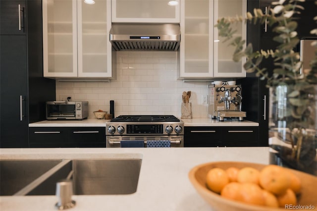 1008 River Park Rd, Buena Vista, CO 81211 - kitchen with wall chimney exhaust hood, stainless steel gas range, light countertops, and tasteful backsplash