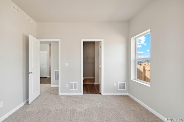 5913 Sawdust Dr, Brighton, CO 80601 - unfurnished bedroom with a spacious closet, carpet floors, baseboards, and a closet