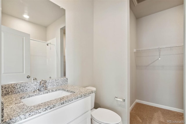 5913 Sawdust Dr, Brighton, CO 80601 - full bathroom with a spacious closet, baseboards, a shower with shower curtain, toilet, and vanity