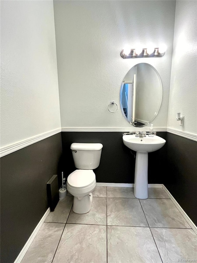 bathroom featuring toilet and tile patterned floors