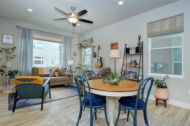 dining space featuring light hardwood / wood-style floors and ceiling fan