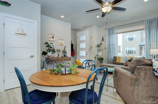 dining area with ceiling fan and light hardwood / wood-style floors