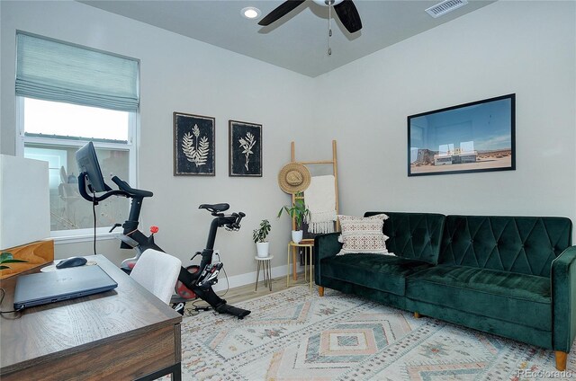 living room featuring ceiling fan and hardwood / wood-style floors