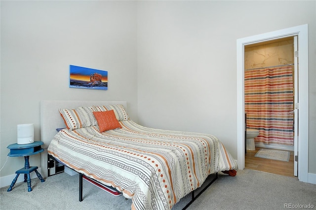 carpeted bedroom with ensuite bathroom