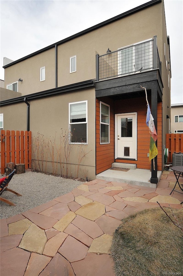 back of house featuring a balcony, cooling unit, and a patio area