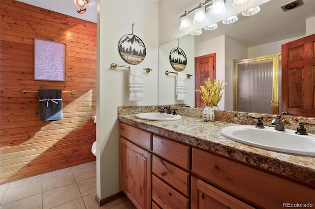 bathroom with vanity, a shower with shower door, tile patterned floors, and toilet