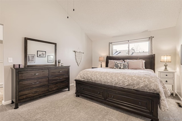 carpeted bedroom with lofted ceiling and a textured ceiling