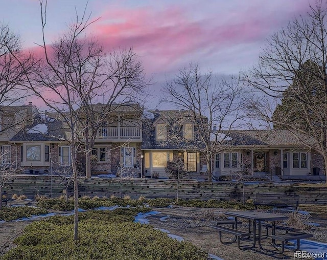 view of back house at dusk