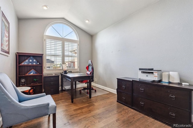 home office featuring lofted ceiling, dark wood-style floors, and baseboards