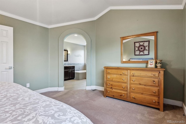 bedroom with baseboards, light colored carpet, crown molding, vaulted ceiling, and arched walkways