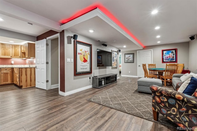 living room with dark wood finished floors, baseboards, and recessed lighting