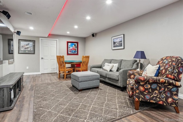 living room with wood finished floors, recessed lighting, and baseboards