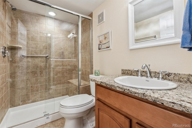 full bathroom with toilet, a stall shower, and vanity