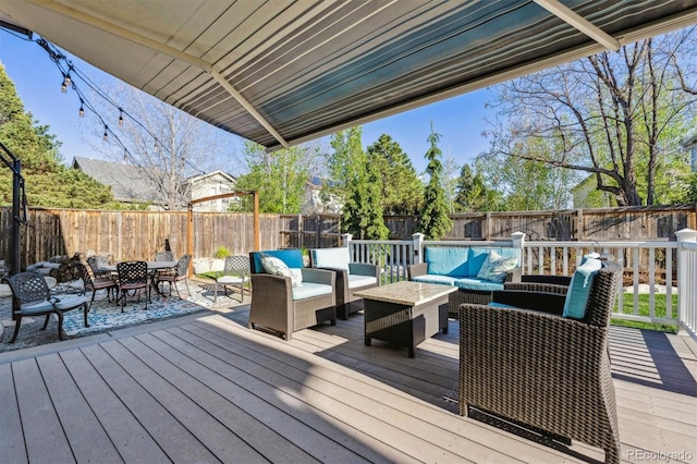wooden deck featuring outdoor lounge area, a fenced backyard, and outdoor dining space