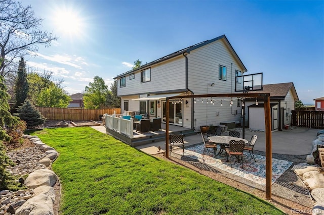 back of house with an outdoor living space, a deck, and a patio area
