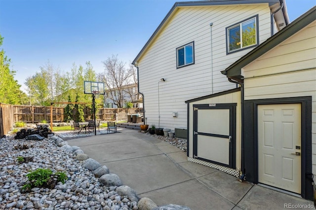 view of side of home with a fenced backyard and a patio area