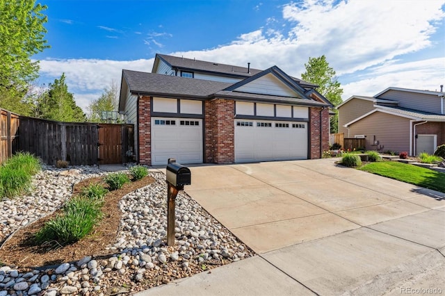 view of front of property featuring brick siding, an attached garage, concrete driveway, and fence