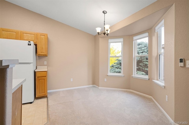 11640 W 62nd Pl Unit 203, Arvada, CO 80004 - unfurnished dining area featuring lofted ceiling, a chandelier, and light colored carpet