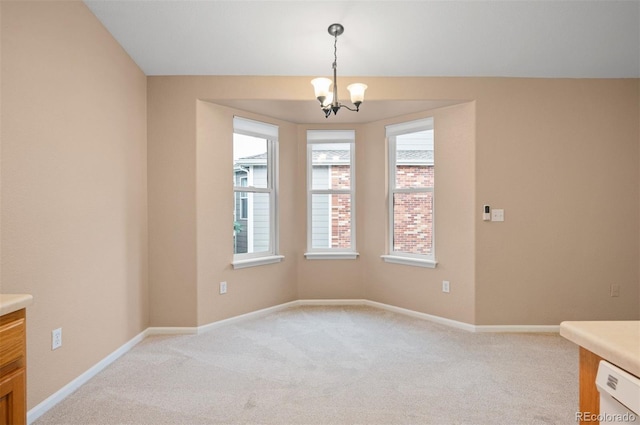 11640 W 62nd Pl Unit 203, Arvada, CO 80004 - unfurnished dining area featuring light colored carpet and a chandelier