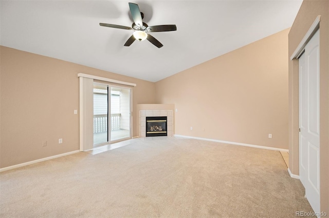 11640 W 62nd Pl Unit 203, Arvada, CO 80004 - unfurnished living room featuring light colored carpet, a ceiling fan, a tile fireplace, and vaulted ceiling