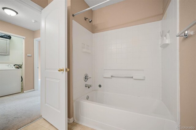 11640 W 62nd Pl Unit 203, Arvada, CO 80004 - bathroom with washer / clothes dryer, washtub / shower combination, and tile patterned flooring