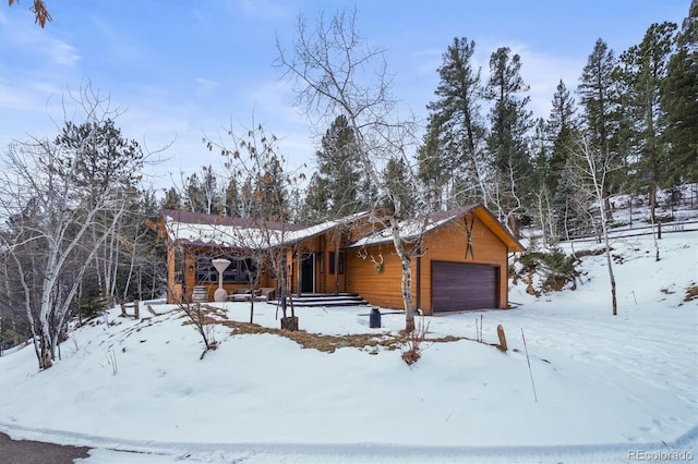 log-style house with a garage