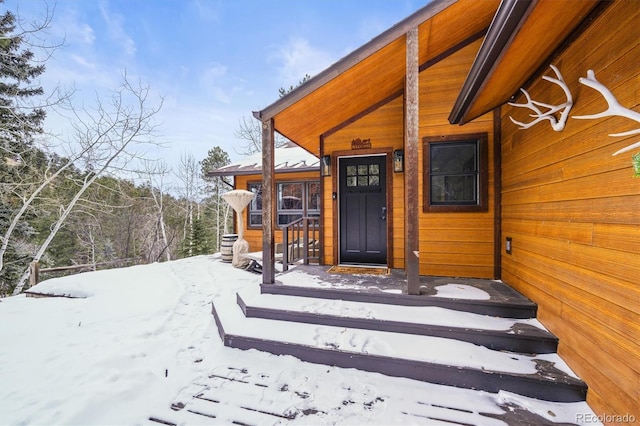 view of snow covered property entrance