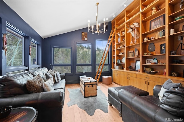 living room featuring an inviting chandelier, light hardwood / wood-style flooring, vaulted ceiling, and plenty of natural light