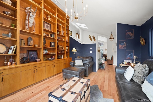 living room with a skylight, light hardwood / wood-style flooring, and a notable chandelier