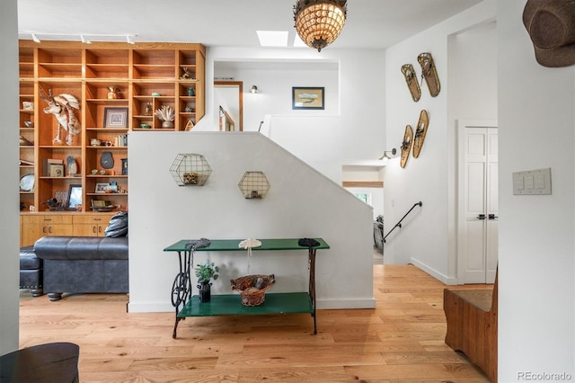 interior space featuring light hardwood / wood-style floors and a skylight