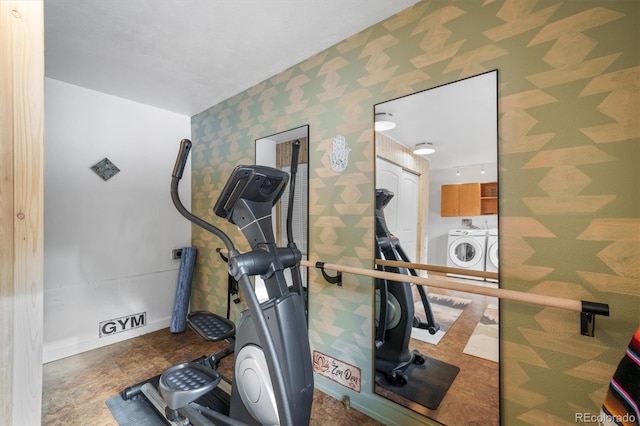 workout room featuring washing machine and clothes dryer