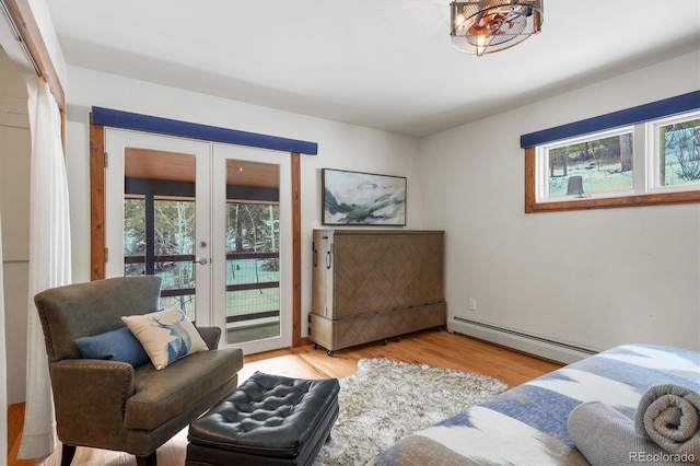 living room featuring a baseboard heating unit, light wood-type flooring, and french doors