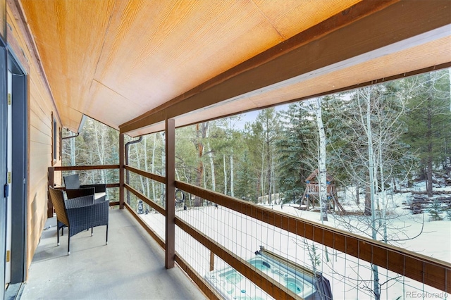 sunroom / solarium with lofted ceiling and wooden ceiling