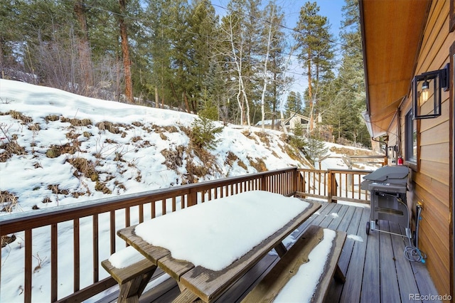 snow covered deck featuring grilling area