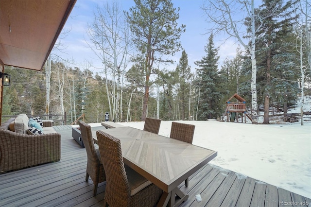 snow covered deck with a playground