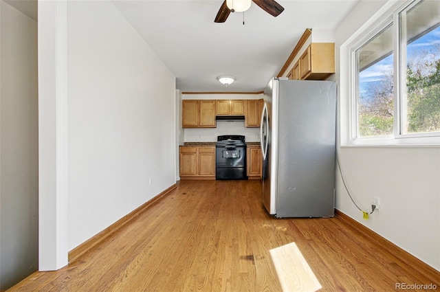 7065 Ingalls Ct, Arvada, CO 80003 - kitchen featuring freestanding refrigerator, black range with electric cooktop, under cabinet range hood, a ceiling fan, and light wood-type flooring