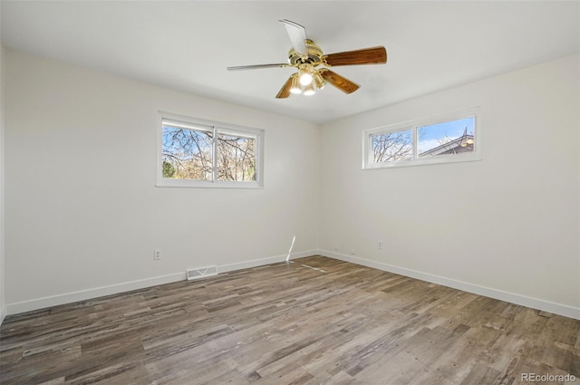7065 Ingalls Ct, Arvada, CO 80003 - empty room featuring plenty of natural light, wood finished floors, and baseboards