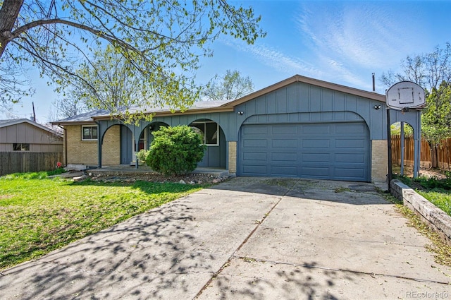 7065 Ingalls Ct, Arvada, CO 80003 - single story home featuring driveway, an attached garage, brick siding, and covered porch