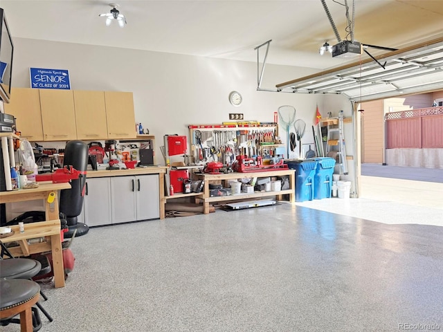 garage with a garage door opener and a workshop area