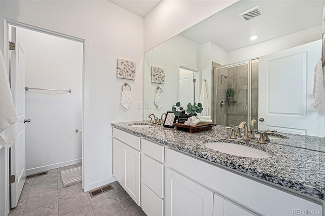 2054 S Upham Way, Denver, CO 80227 - bathroom featuring a stall shower and double vanity