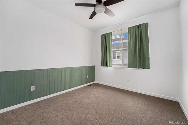2054 S Upham Way, Denver, CO 80227 - empty room with ceiling fan, dark carpet, and wainscoting