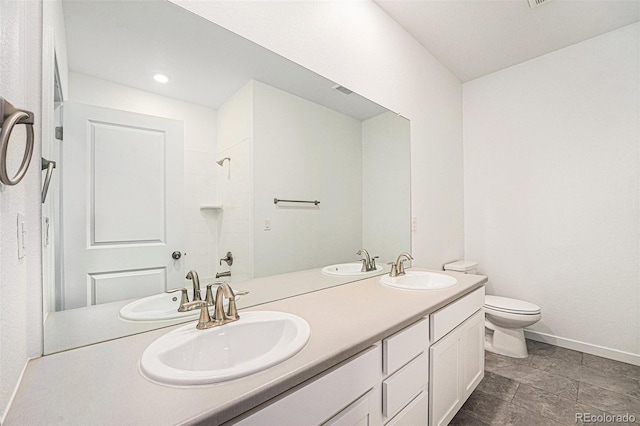 2054 S Upham Way, Denver, CO 80227 - bathroom featuring double vanity, a shower, and stone finish flooring