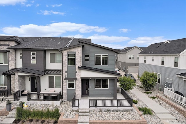 2054 S Upham Way, Denver, CO 80227 - view of front of property featuring a residential view, a standing seam roof, and a patio