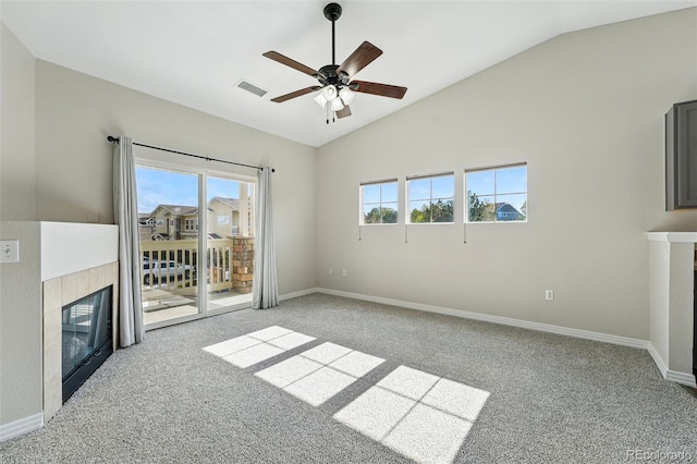 9434 Ashbury Cir Unit 203, Parker, CO 80134 - unfurnished living room featuring a fireplace, lofted ceiling, carpet, plenty of natural light, and ceiling fan