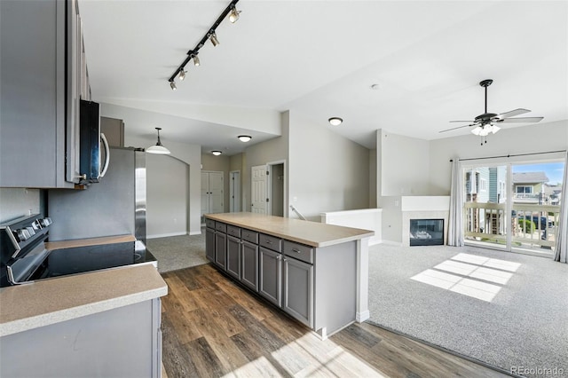 9434 Ashbury Cir Unit 203, Parker, CO 80134 - kitchen featuring gray cabinets, stainless steel appliances, light countertops, a ceiling fan, and vaulted ceiling